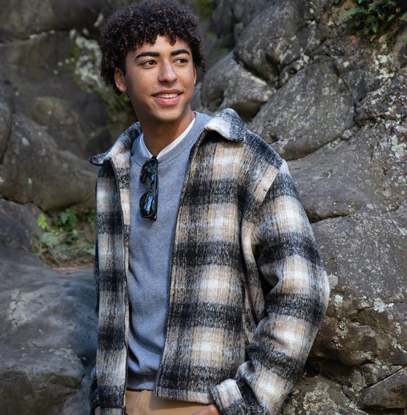 boy posing wearing flannel jacket